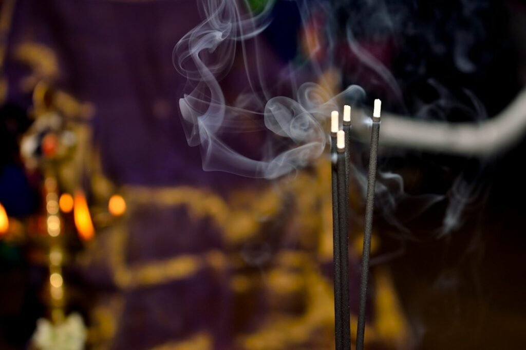 Close-up of burning incense sticks offered during prayers in an Indian village