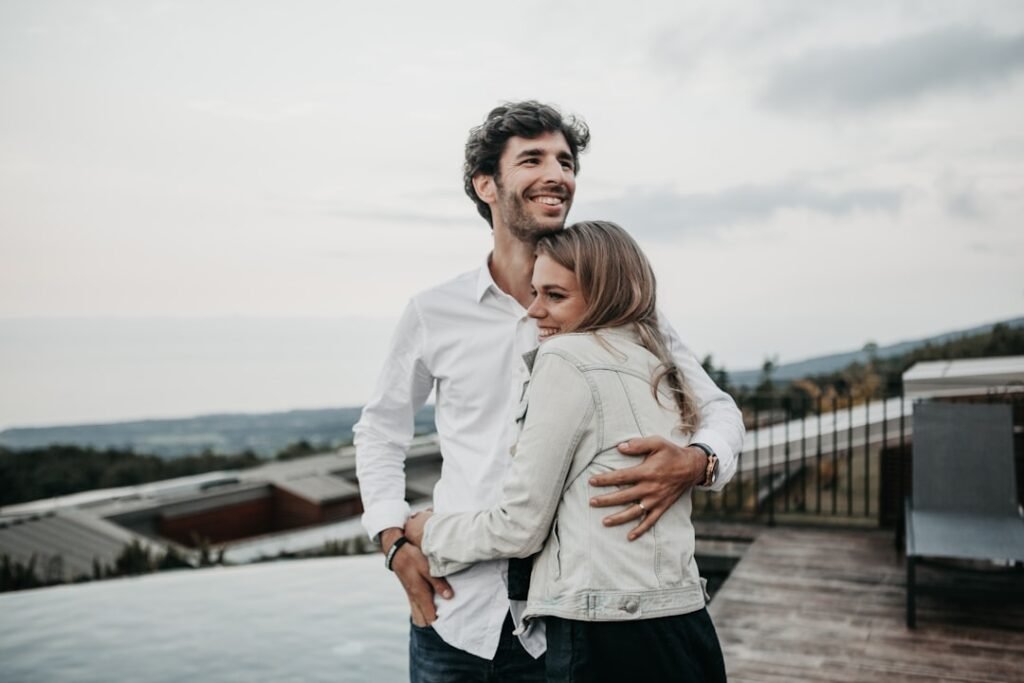 Couple embracing joyfully in sunlight