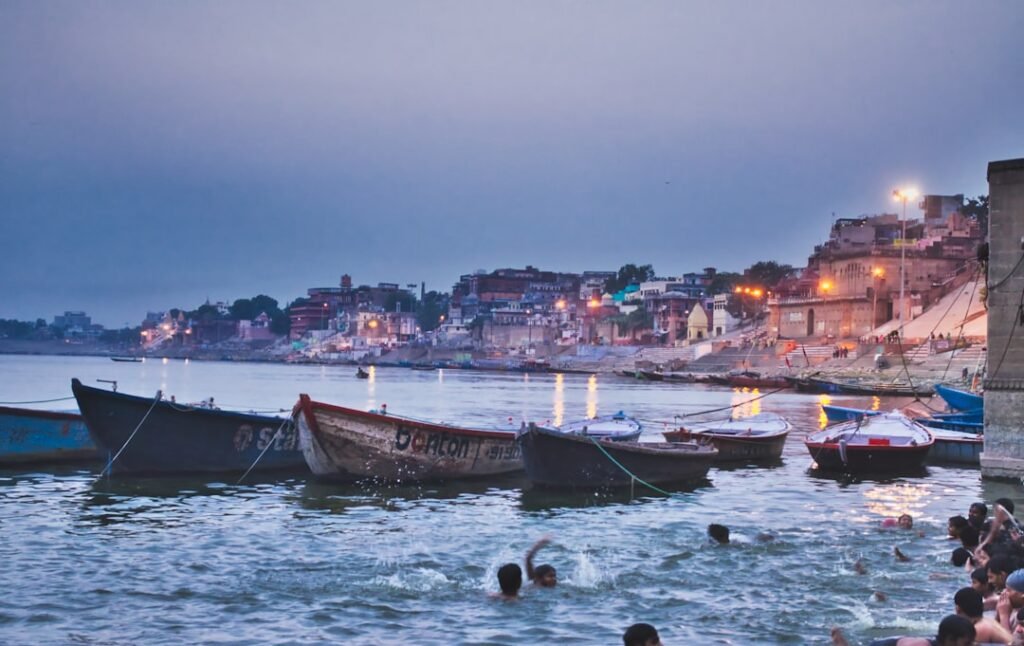 Rowing boats near a river at dawn, representing Pitra Dosha remedies