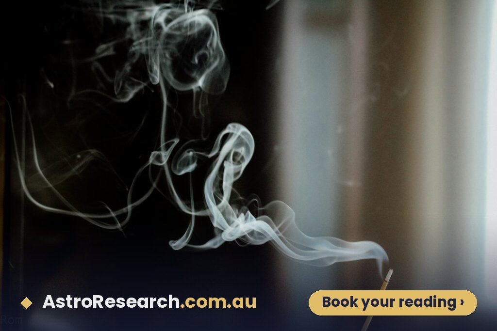 Person meditating with rising incense smoke, representing Rahu remedies