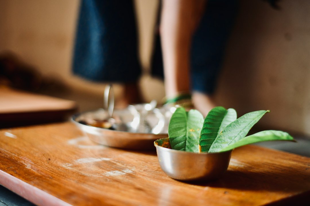 Traditional puja setting with mango leaves, turmeric and betel leaves