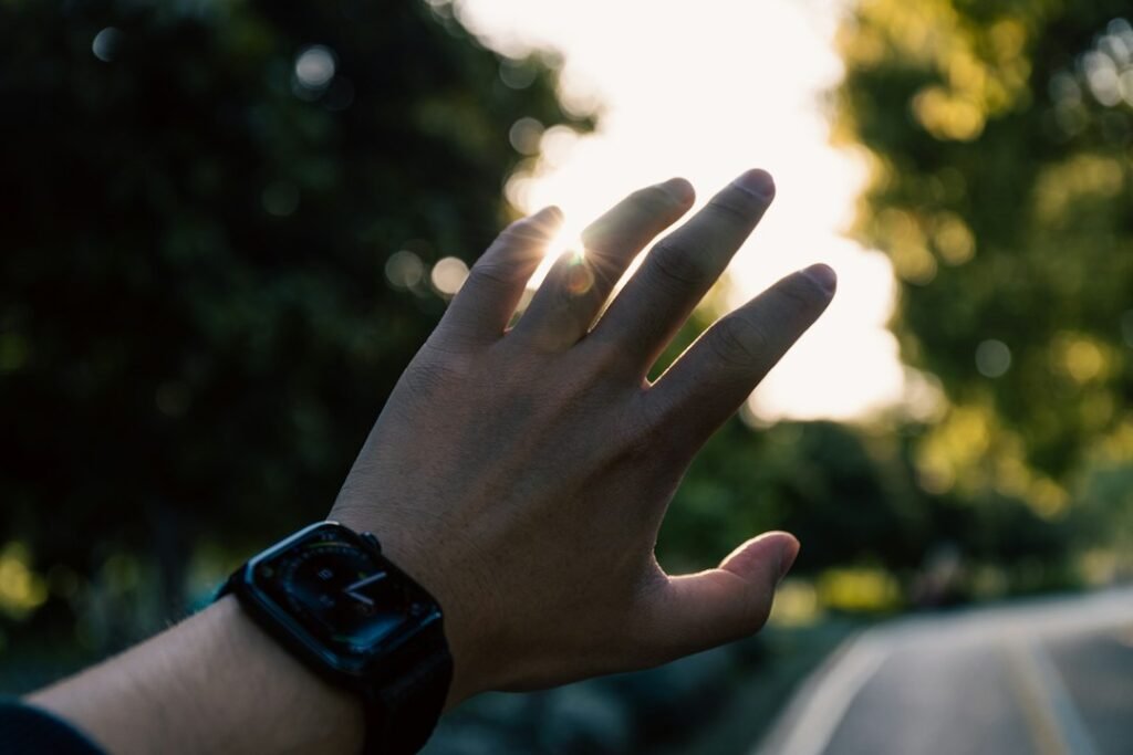 Person holding hand out to the morning sun