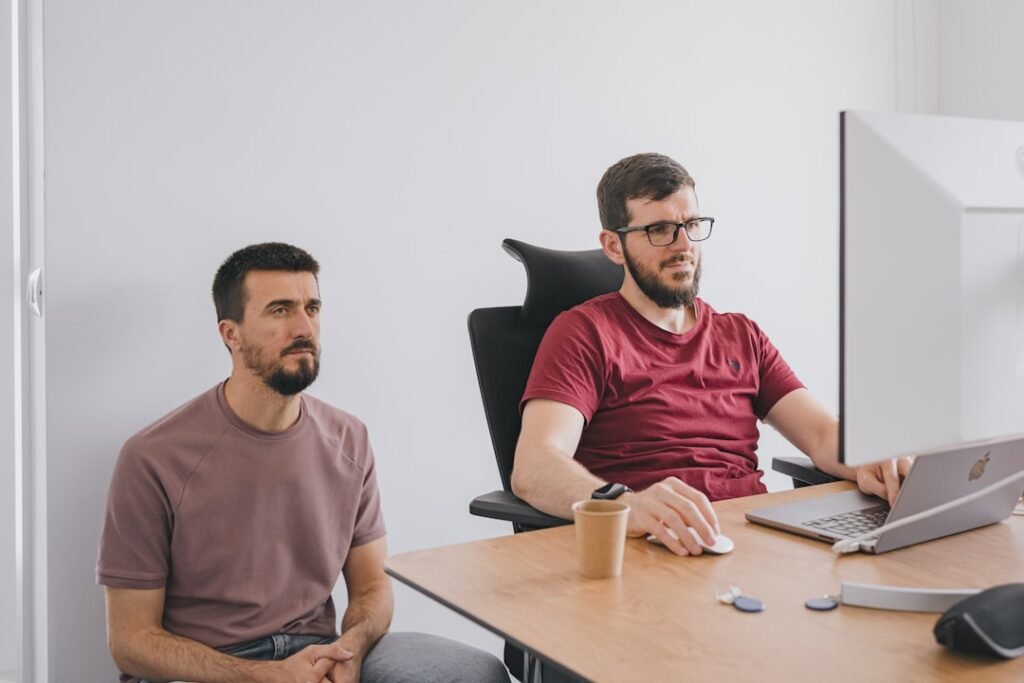 Two people discussing plans together in a bright office
