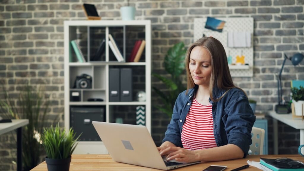 Woman calmly reviewing documents at a desk in daylight