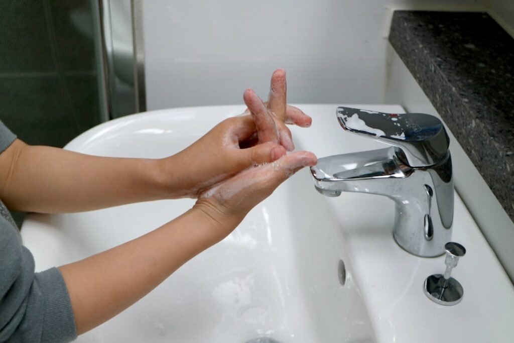 woman washing hands bathroom sink daylight