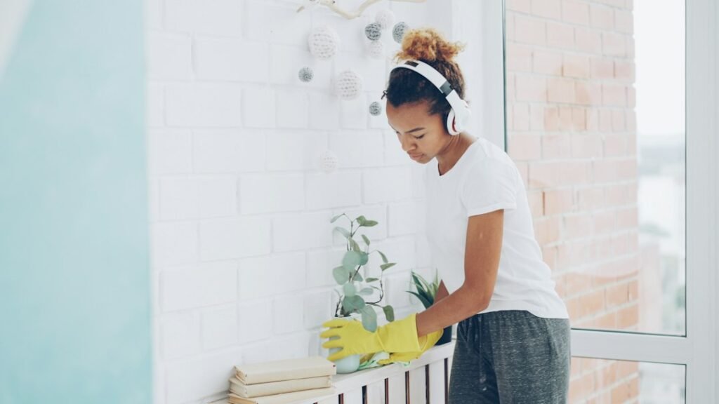 Woman cheerfully decluttering and tidying her home in daylight