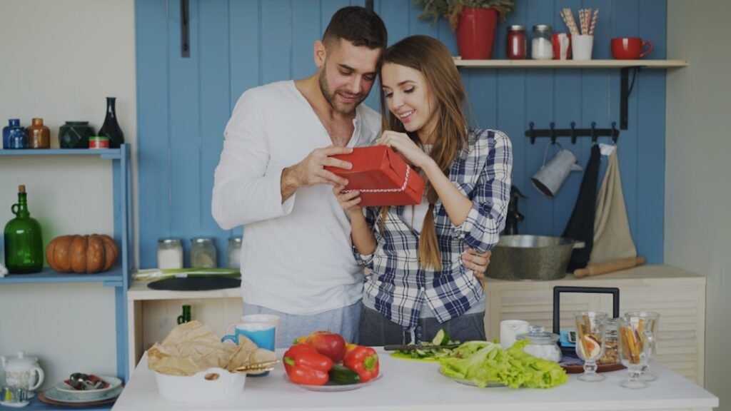 Couple sharing a happy moment in their kitchen in daylight