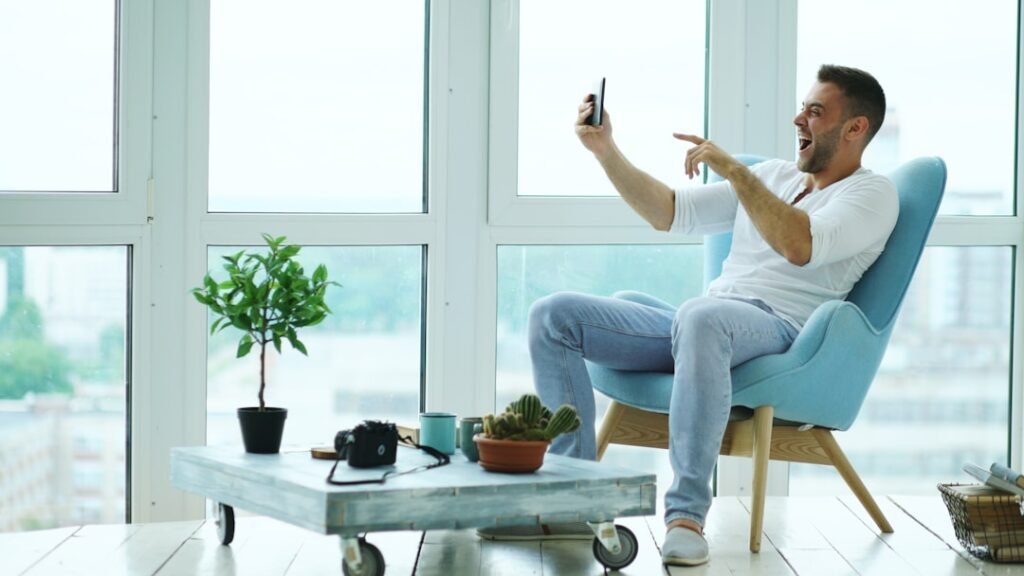 Man sitting focused at a home workspace in daylight