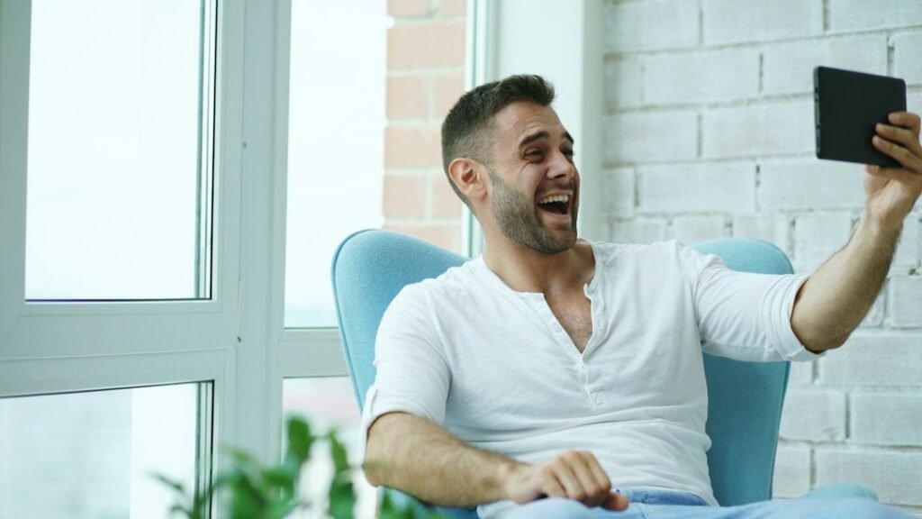 Man on a video call from a home office in daylight