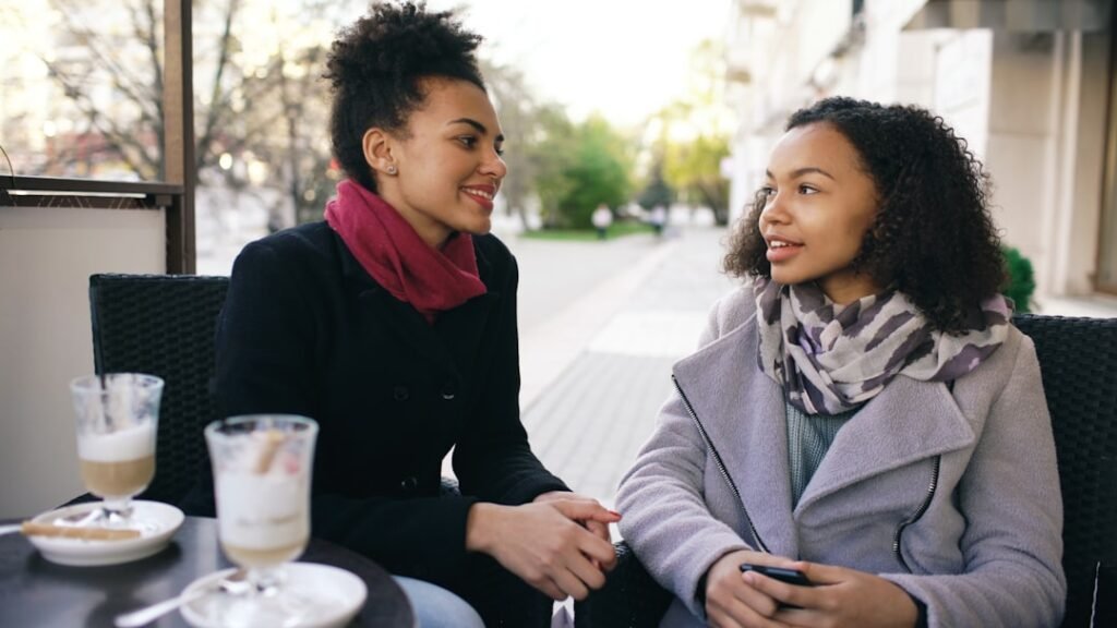 Two women having a meaningful conversation at a daylight cafe