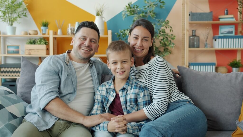 Happy family relaxing together on a couch in daylight