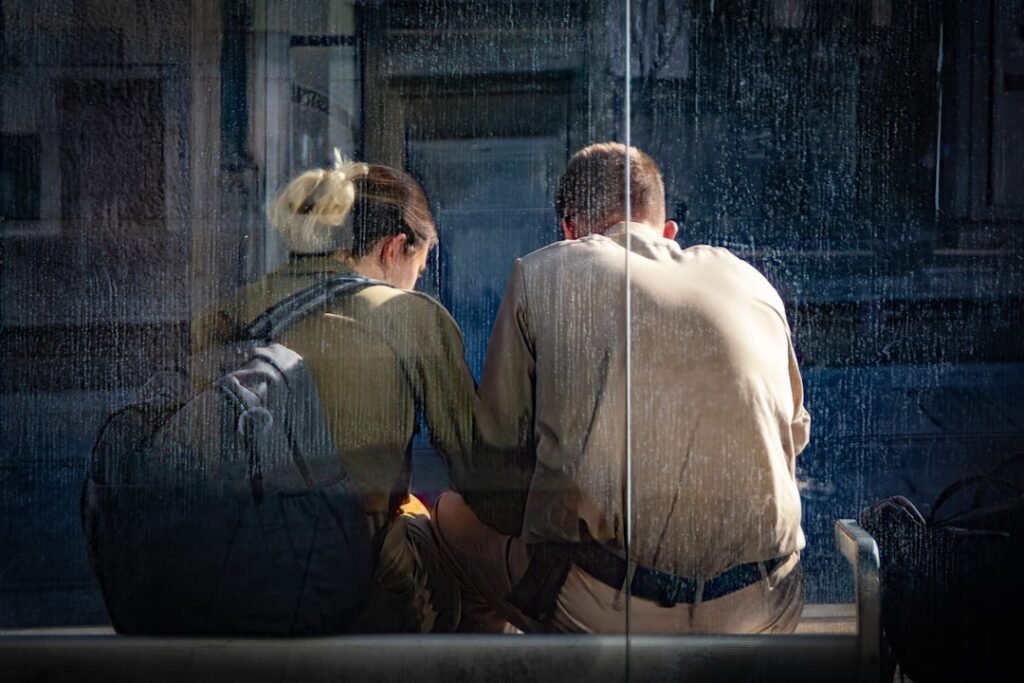 Couple holding hands and sharing a tender moment by a window