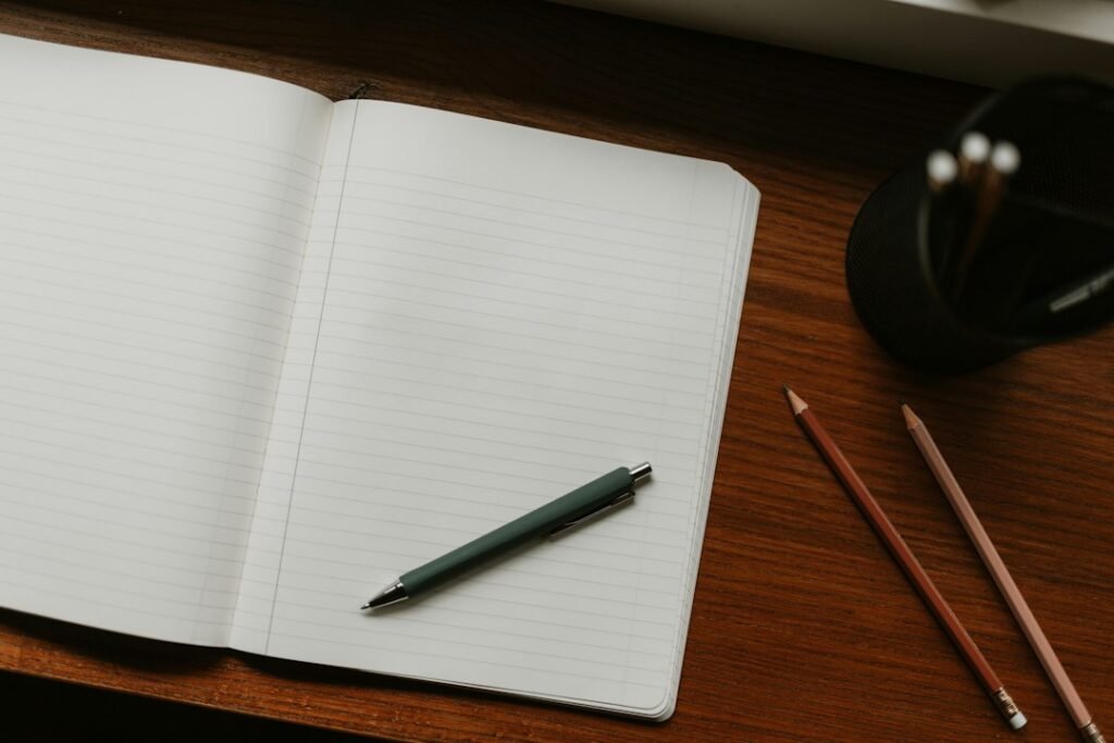 Open notebook with pen and pencils on a desk, representing Budh (Mercury) remedies
