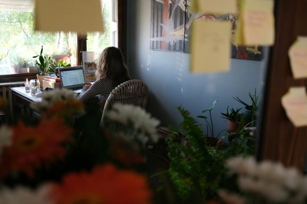 Woman reading and studying at a desk in natural daylight