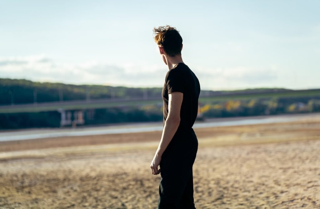 Person looking thoughtfully into the distance in daylight