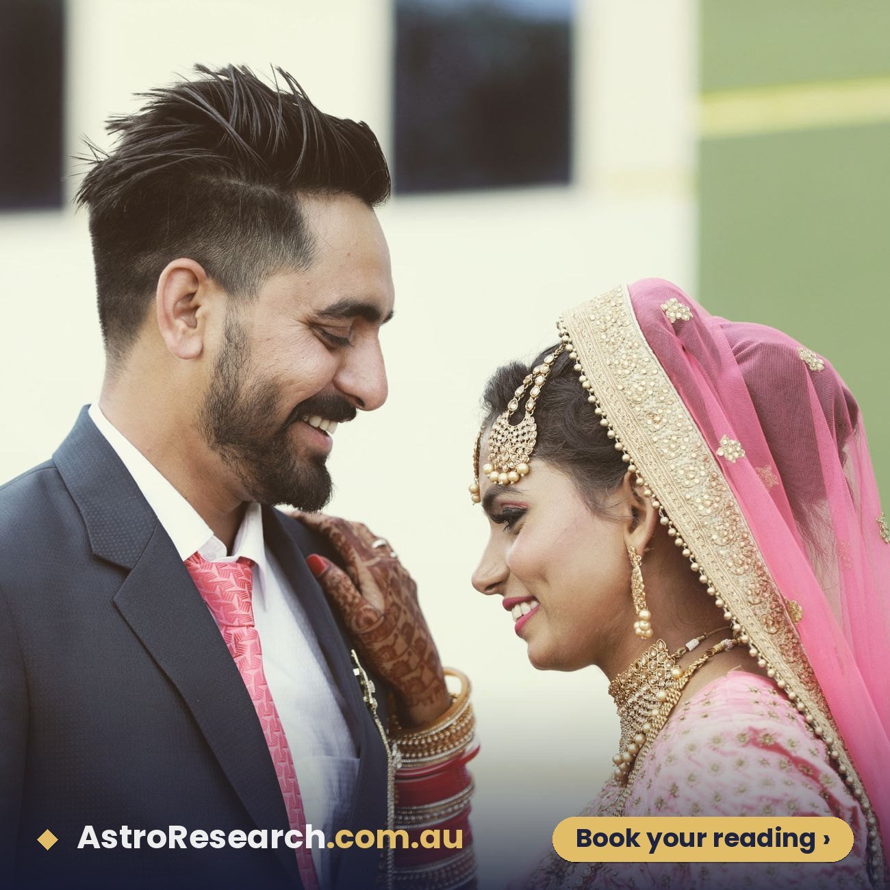 Joyful Indian bride and groom smiling at each other on their wedding day