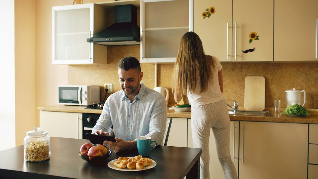 Couple planning together in a sunlit kitchen, booking an online Vedic astrology consultation from Canberra